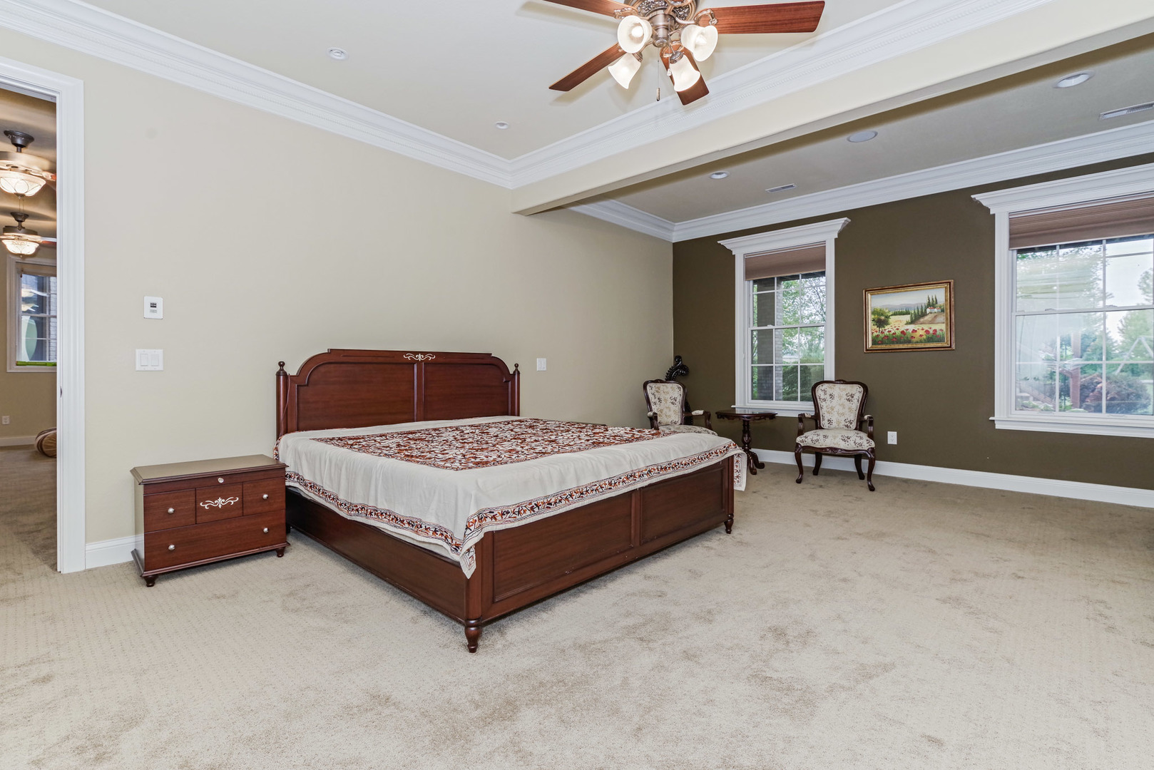 10470 Sturbridge Road Bloomington, IL 61705 - Photo 51 of 75 a bedroom with a large bed and a chandelier