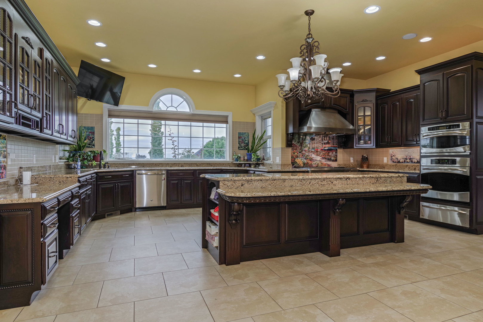 10470 Sturbridge Road Bloomington, IL 61705 - Photo 10 of 75 a kitchen with kitchen island granite countertop a sink stove and cabinets