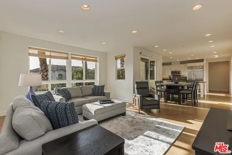 a dining room with furniture window and wooden floor