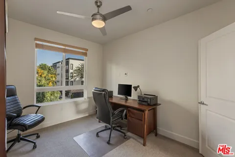 a bedroom with a large bed and a large window