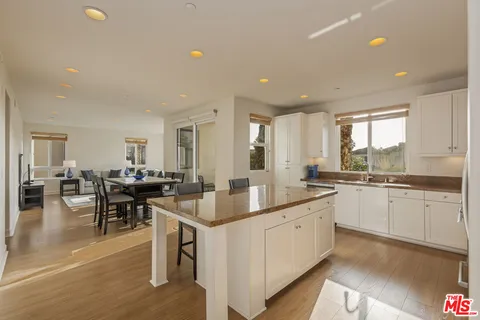 a kitchen with a sink refrigerator and microwave