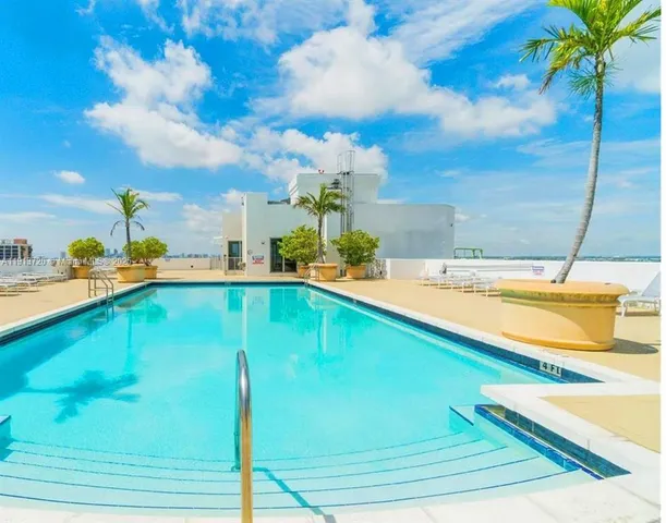 a view of a swimming pool with a lounge chair