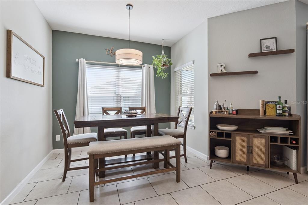 1725 Reflection Lane St. Cloud, FL 34771 - Photo 16 of 37 a view of a dining room with furniture and window