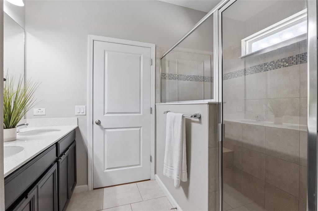 1725 Reflection Lane St. Cloud, FL 34771 - Photo 22 of 37 a bathroom with a shower and a sink