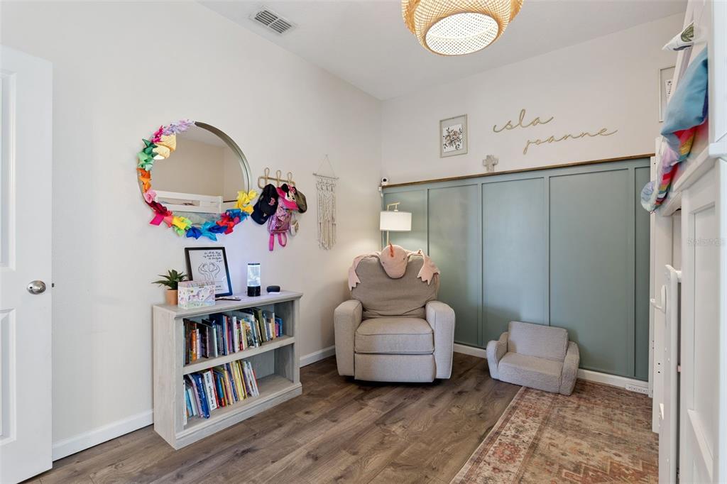 1725 Reflection Lane St. Cloud, FL 34771 - Photo 26 of 37 a living room with furniture and a book shelf