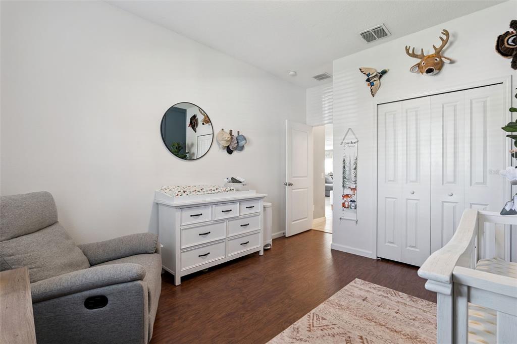 1725 Reflection Lane St. Cloud, FL 34771 - Photo 29 of 37 a living room with furniture and a wooden floor