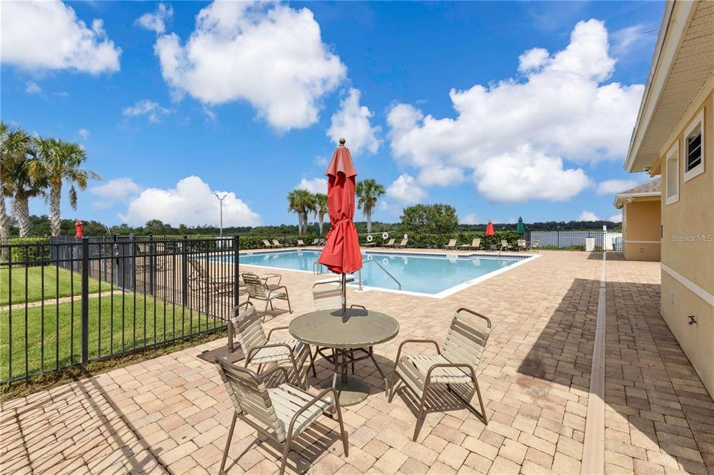 1725 Reflection Lane St. Cloud, FL 34771 - Photo 37 of 37 a view of a lake with couches and wooden floor