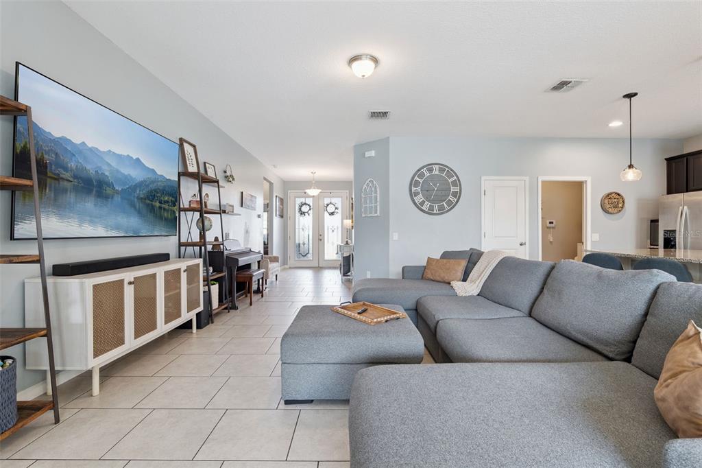 1725 Reflection Lane St. Cloud, FL 34771 - Photo 6 of 37 a living room with furniture and a clock