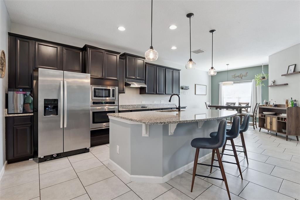 1725 Reflection Lane St. Cloud, FL 34771 - Photo 10 of 37 a kitchen with kitchen island a counter top space appliances and cabinets