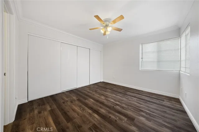 a view of a livingroom with wooden floor and a ceiling fan