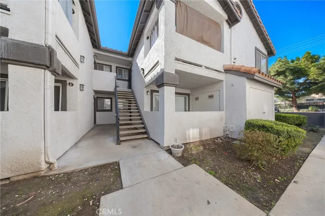 a view of a white building with many windows