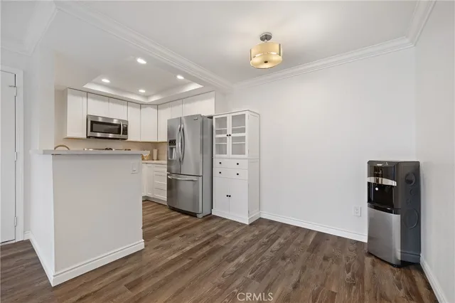 a kitchen with stainless steel appliances a refrigerator sink and microwave