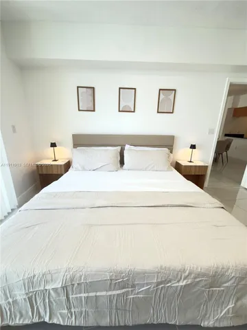 a bedroom with a bed and a night stand