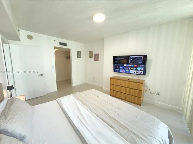 a bedroom with a bed and a cabinets