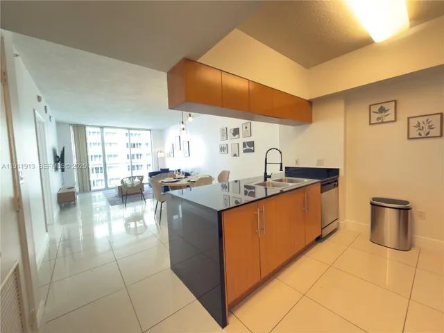 a kitchen with a sink and a stove top oven