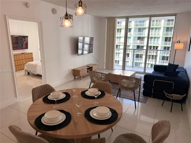 a view of a dining room with furniture and a chandelier