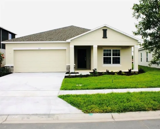 a front view of a house with a garden and plants