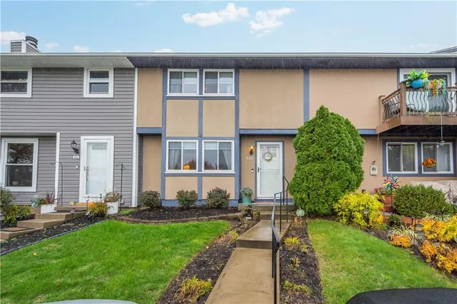 a front view of house and yard with green space