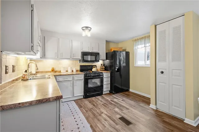 a kitchen with a refrigerator stove and sink