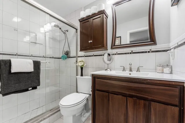 a bathroom with a sink toilet and mirror