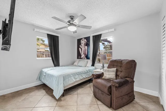 a living room with bed furniture and a window