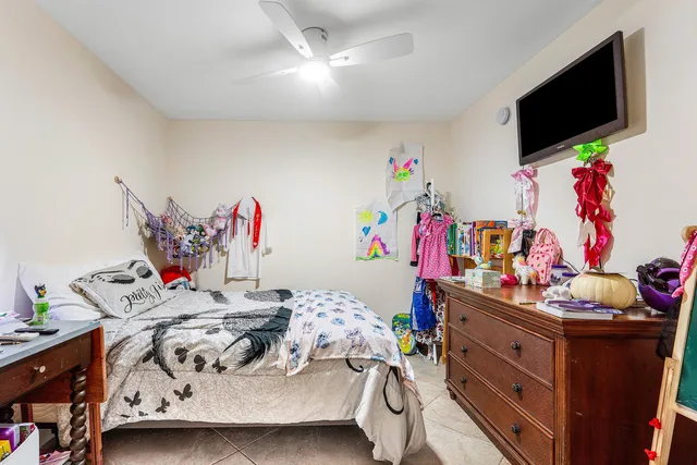 a bedroom with furniture a flat screen tv and a bed
