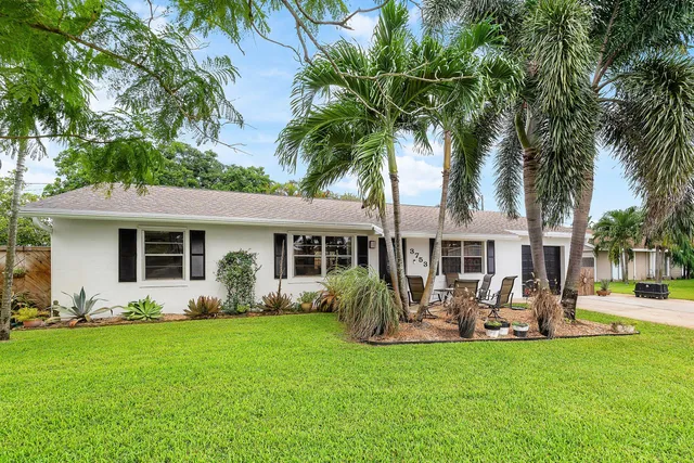 a front view of house with yard and green space