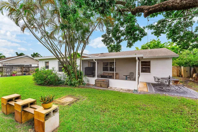 a front view of house with a garden and patio