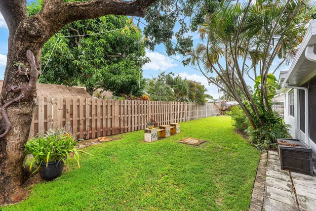 a view of a backyard with a garden and fire pit
