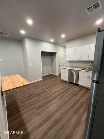 a empty room with wooden floor and window