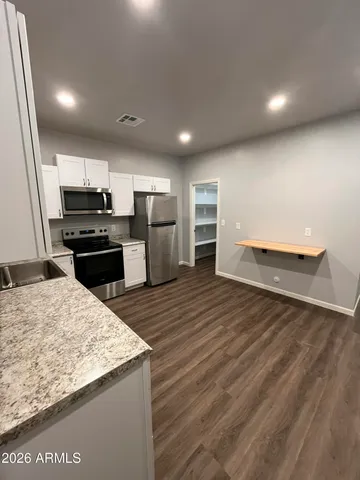 a kitchen with refrigerator and microwave