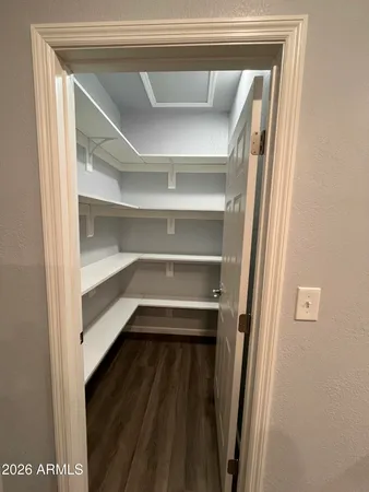 a view of walk in closet with empty racks