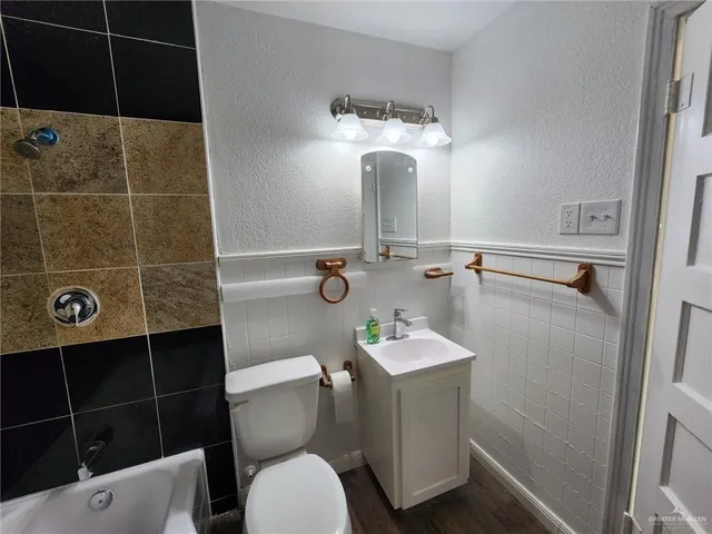a bathroom with a toilet a sink and shower