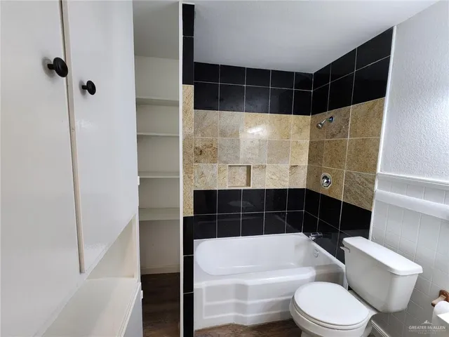 a bathroom with a toilet and a shower