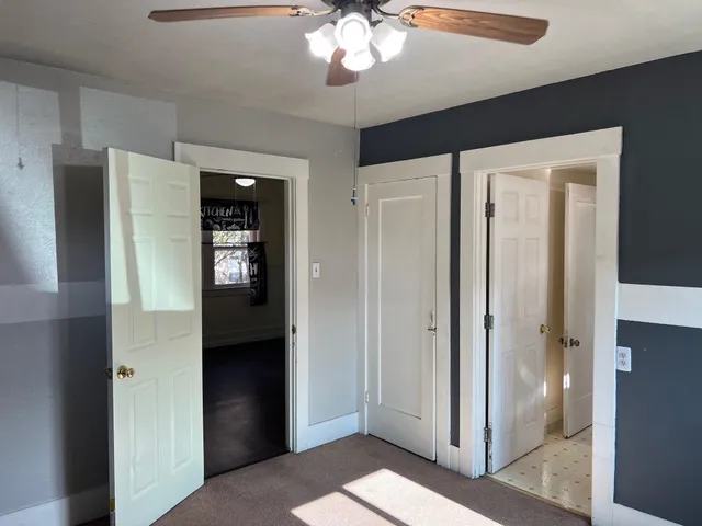 a view of a hallway with wooden shelves