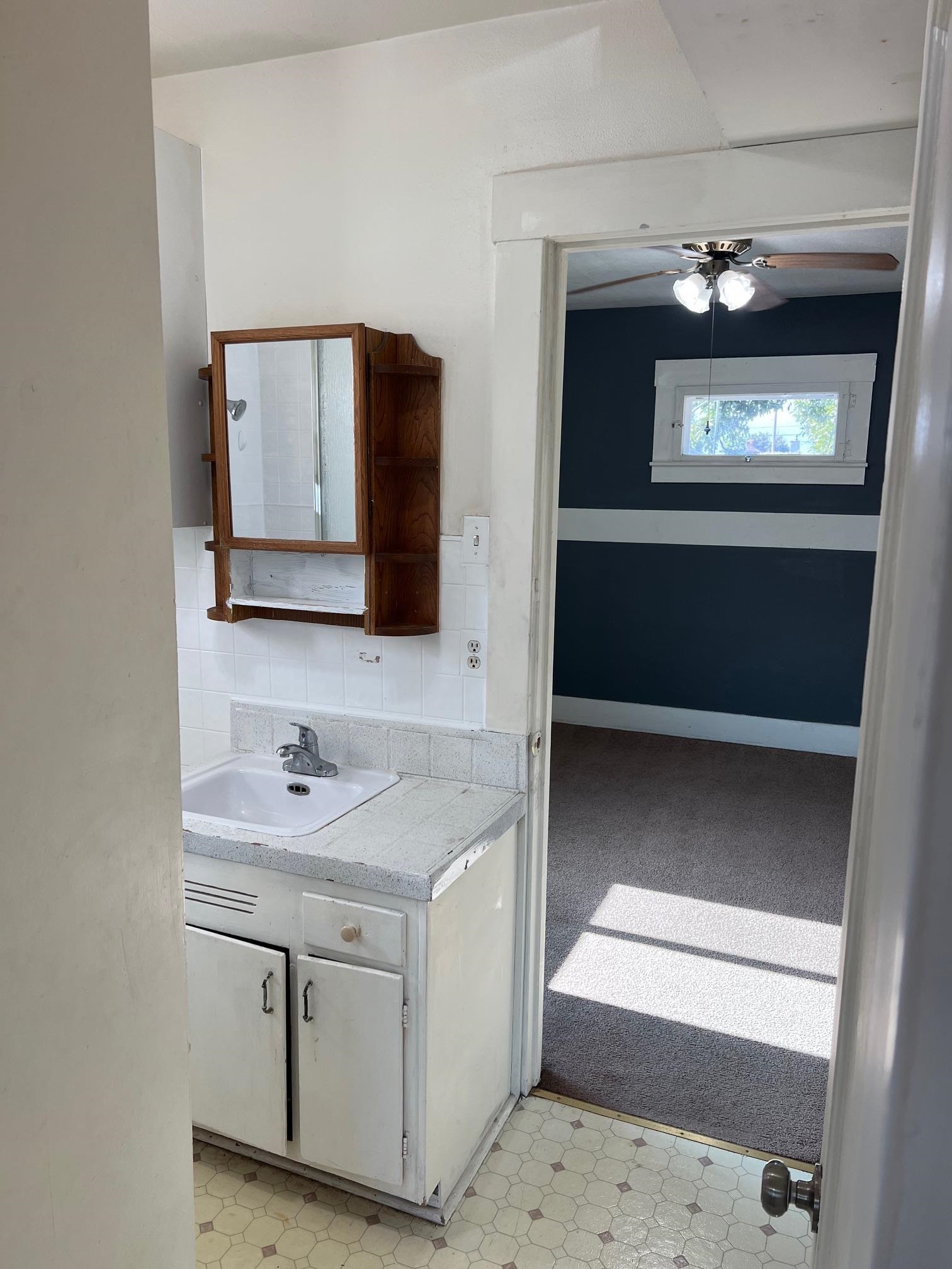 22771 Inyo Street Hayward, CA 94541 - Photo 23 of 29 a bathroom with a sink a light fixture and a mirror