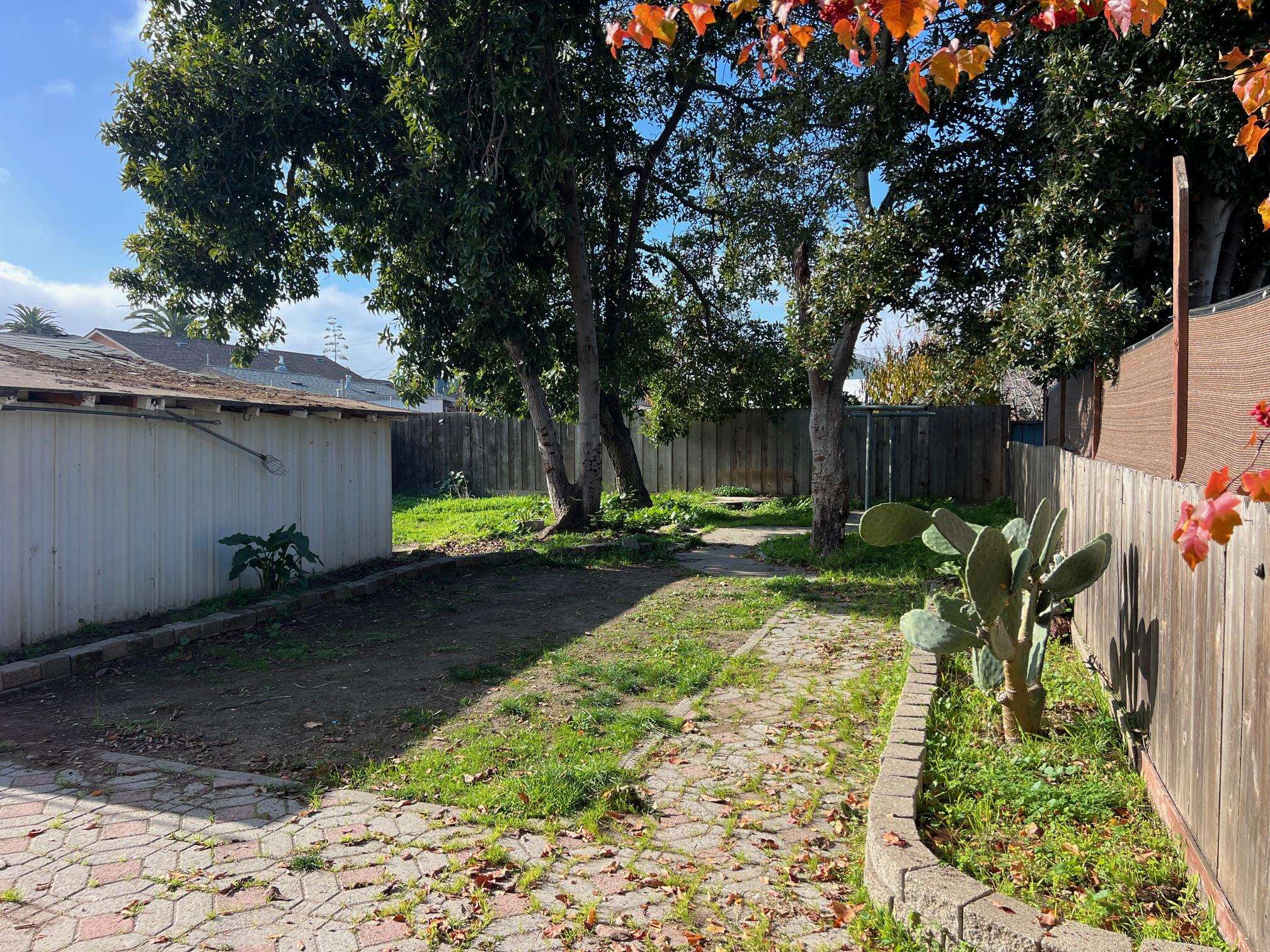 22771 Inyo Street Hayward, CA 94541 - Photo 24 of 29 a view of a backyard house with large trees and flower plants