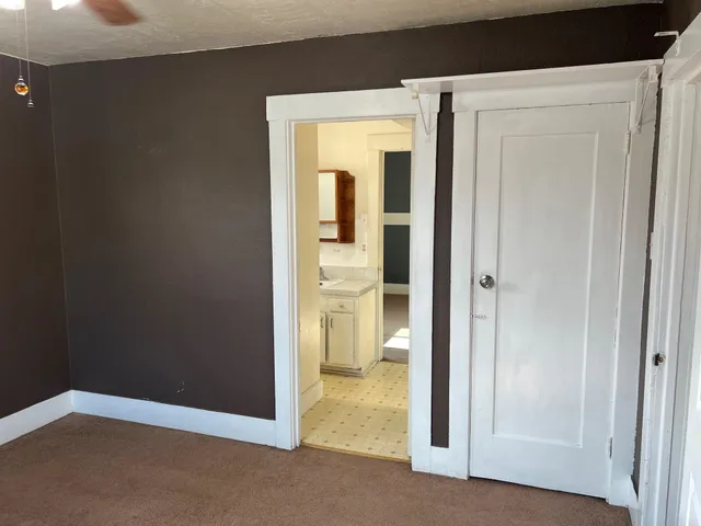 a view of a hallway with a room