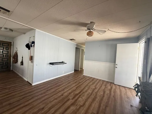 a kitchen with granite countertop a sink cabinets and wooden floor