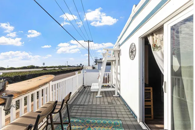 a kitchen with stainless steel appliances a sink dishwasher a stove top oven a refrigerator and dishwasher with wooden floor