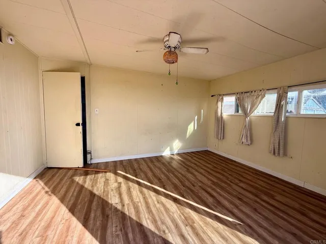 a view of a room with wooden floor