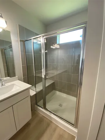 a bathroom with a shower and a sink