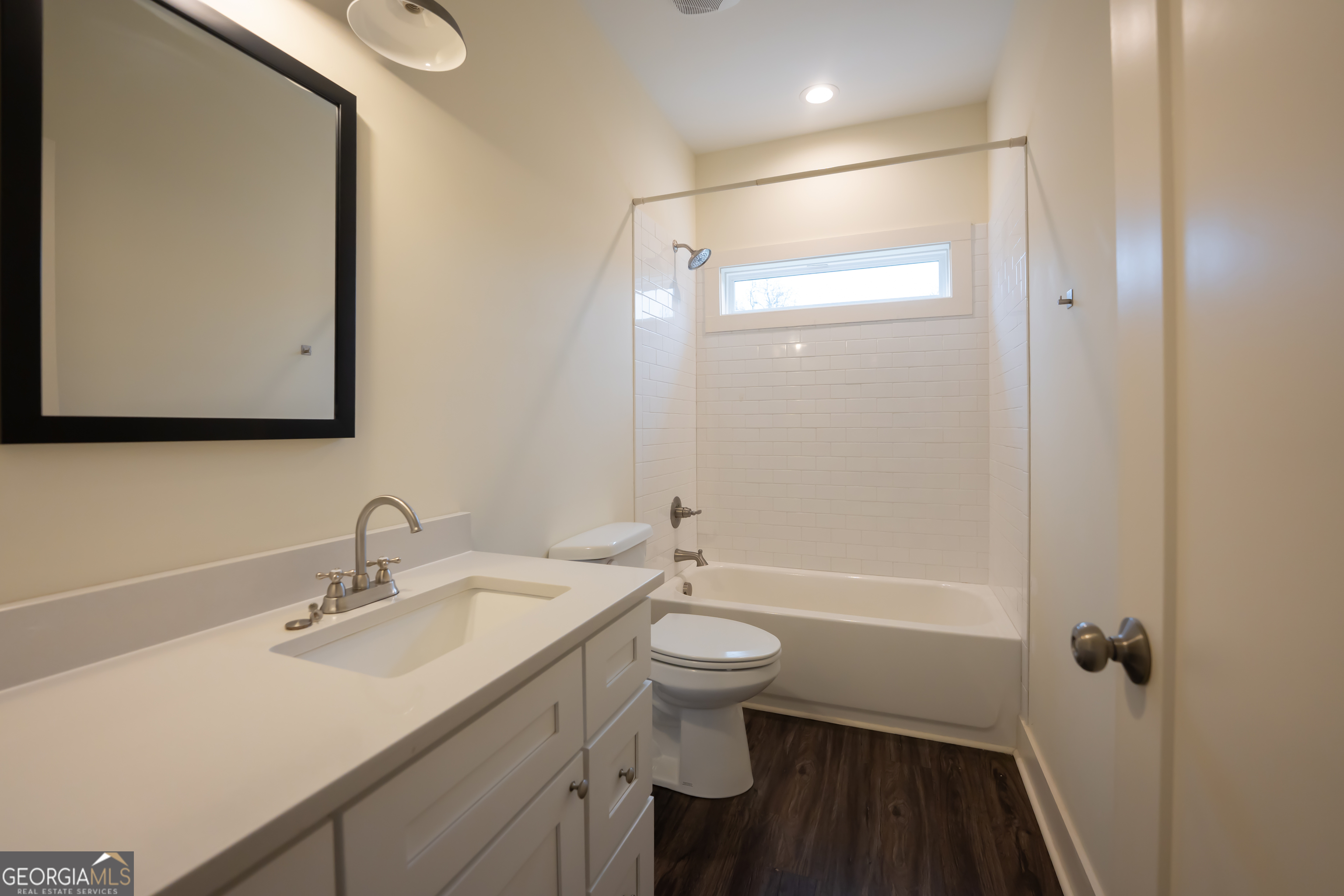 1000 Bell Circle Madison, GA 30650 - Photo 13 of 21 a bathroom with a sink a toilet a mirror and shower