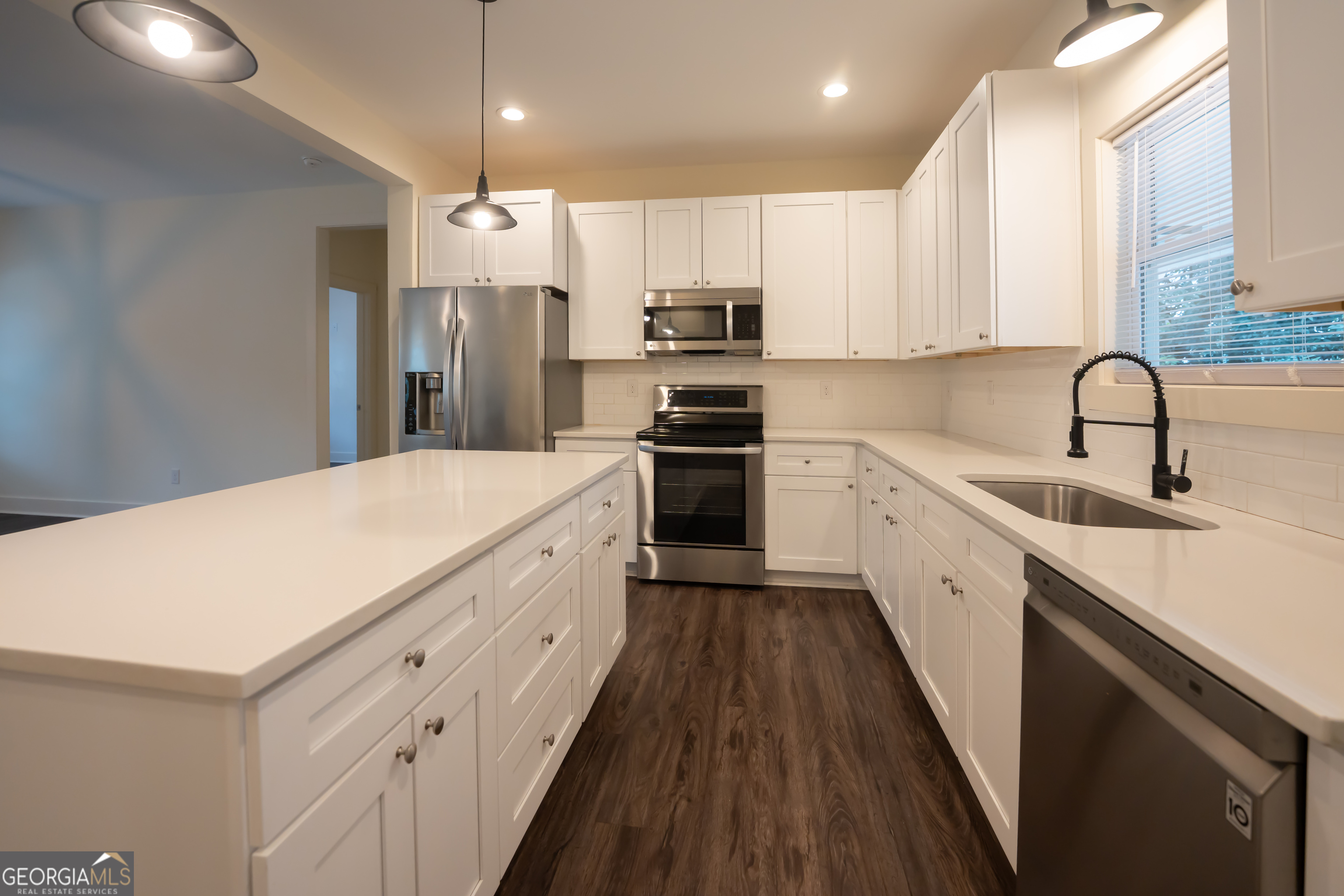 1000 Bell Circle Madison, GA 30650 - Photo 2 of 21 a kitchen with a sink stainless steel appliances and cabinets