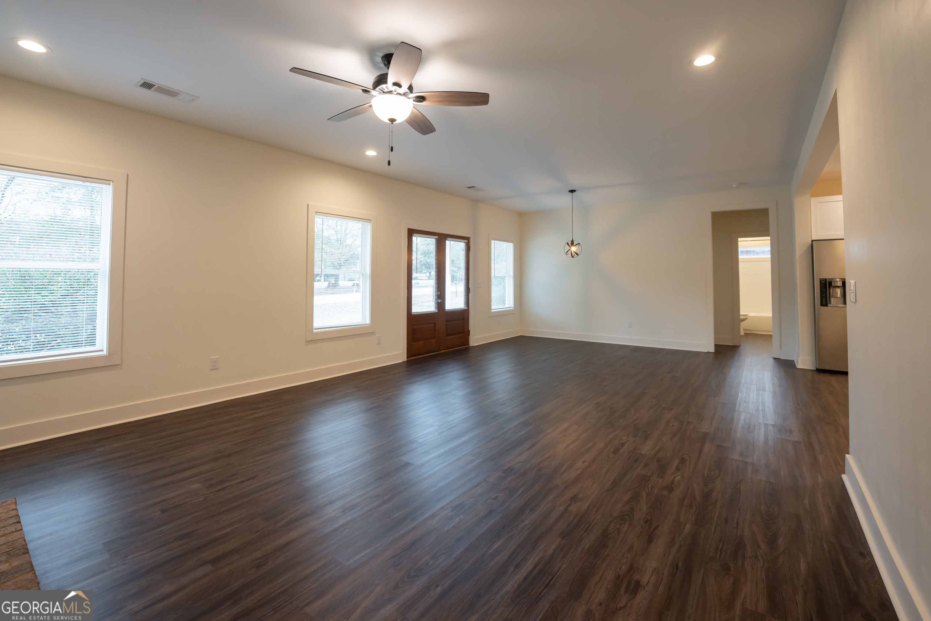 1000 Bell Circle Madison, GA 30650 - Photo 6 of 21 a view of an empty room with a window and wooden floor