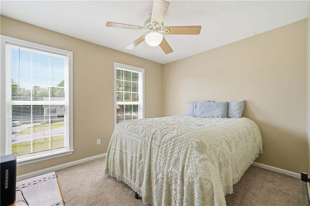 137 Orchard Way Southeast Calhoun, GA 30701 - Photo 11 of 39 a bed sitting in a bedroom next to a window