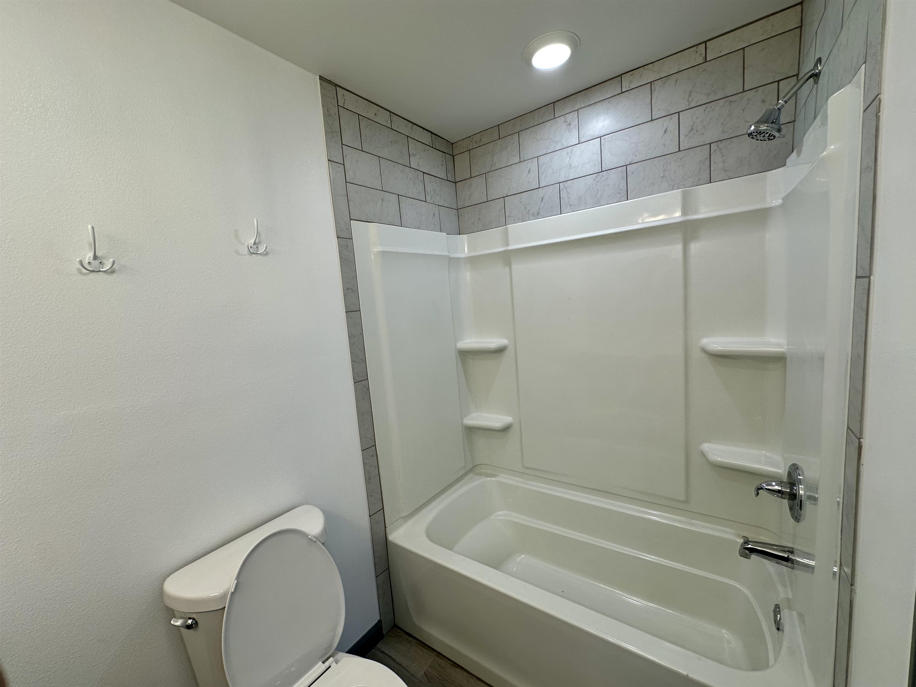 3410 Cactus Trail Kingsland, TX 78639 - Photo 19 of 26 a bathroom with a shower a toilet and a bathtub