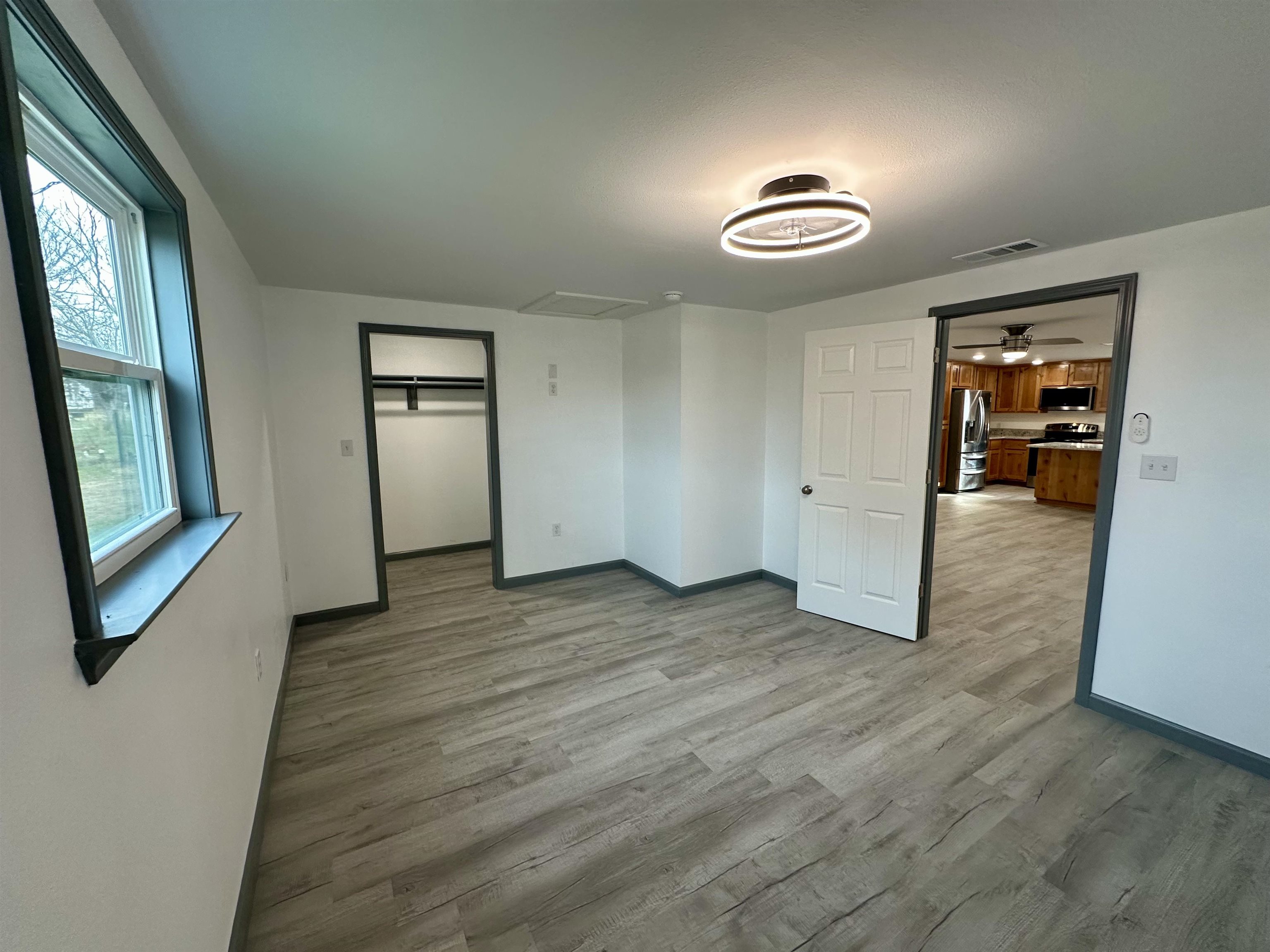 3410 Cactus Trail Kingsland, TX 78639 - Photo 22 of 26 an empty room with wooden floor and windows
