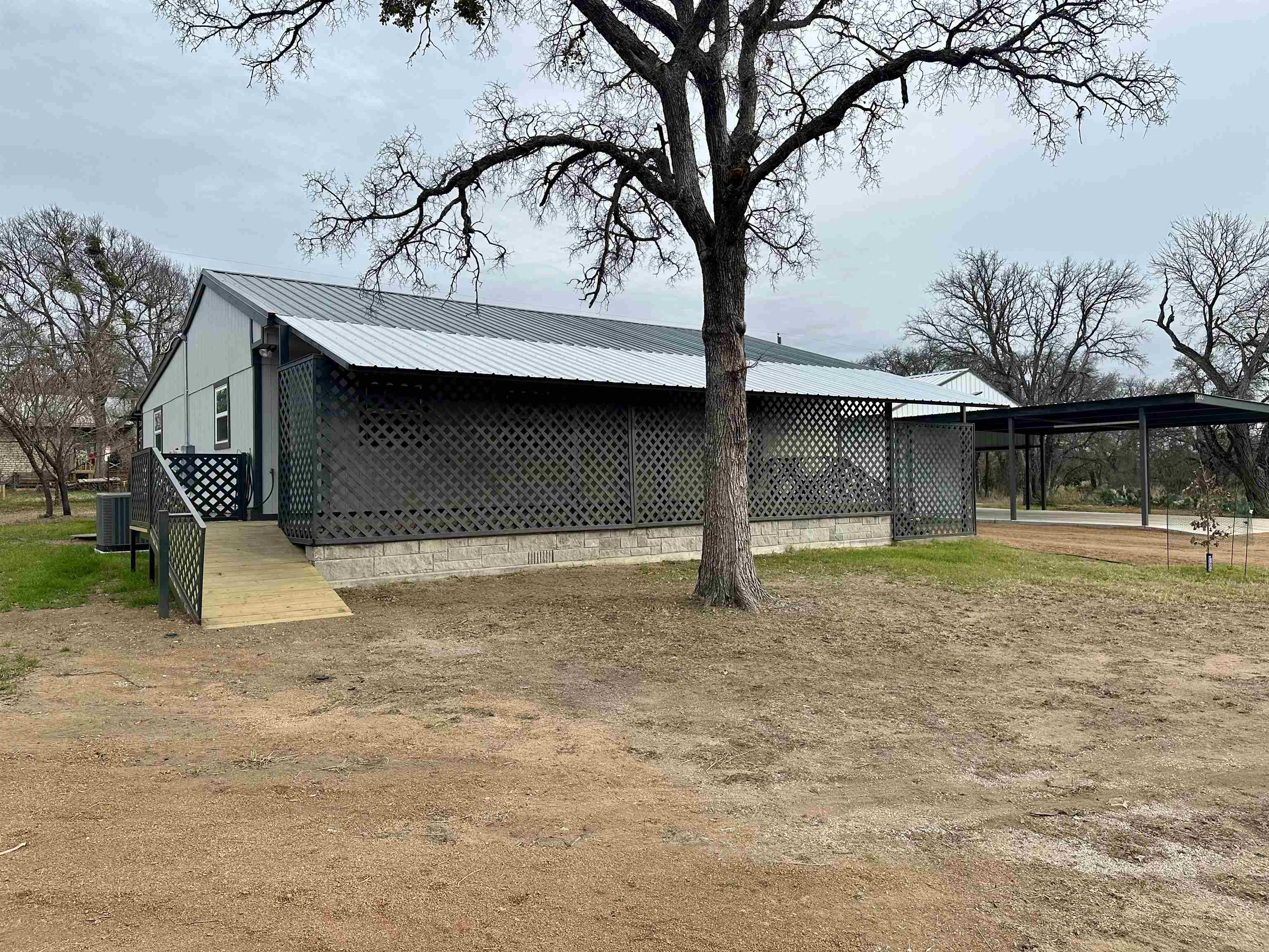 3410 Cactus Trail Kingsland, TX 78639 - Photo 4 of 26 a front view of a house with a yard and garage