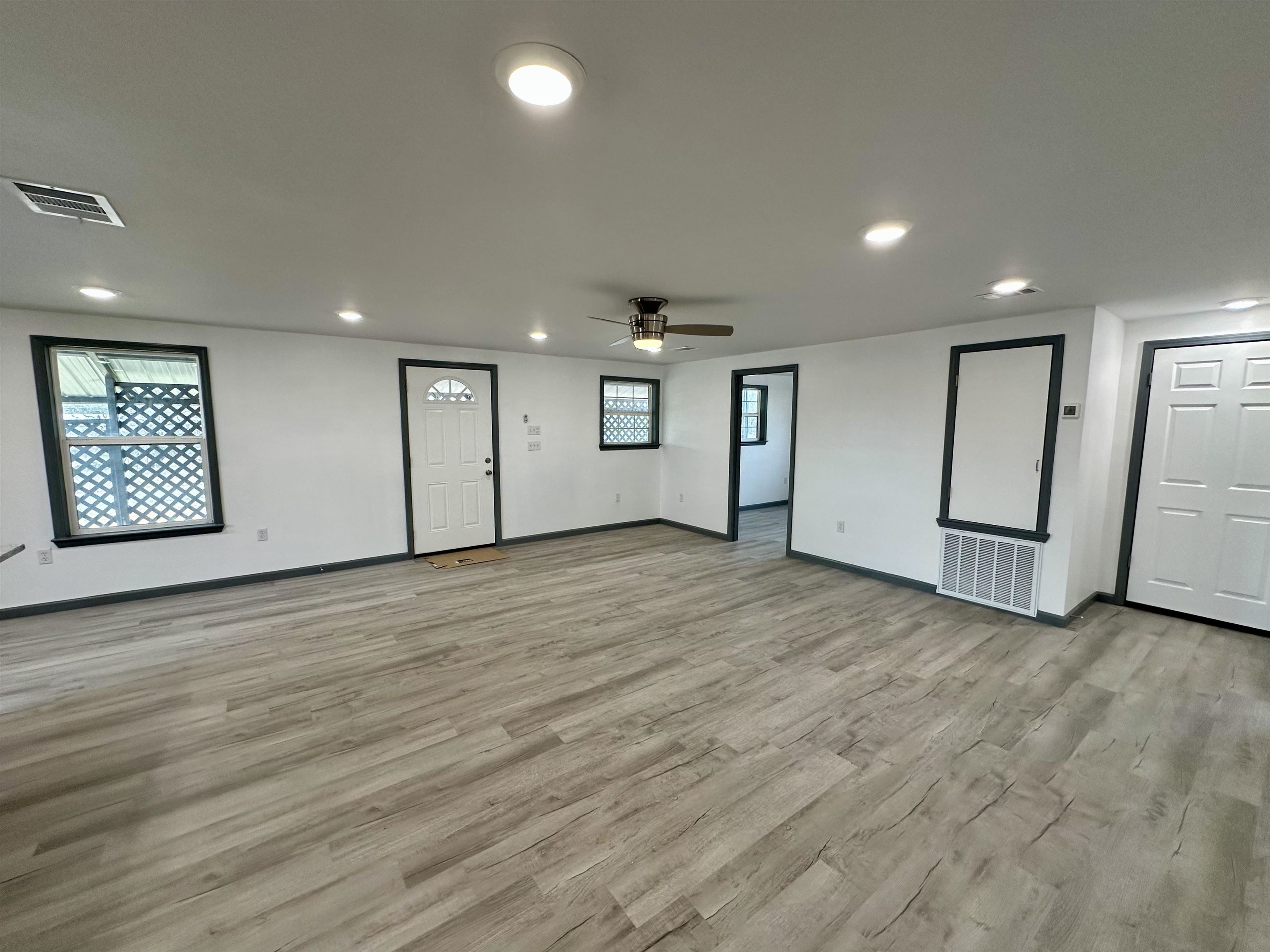 3410 Cactus Trail Kingsland, TX 78639 - Photo 8 of 26 an empty room with wooden floor and white walls